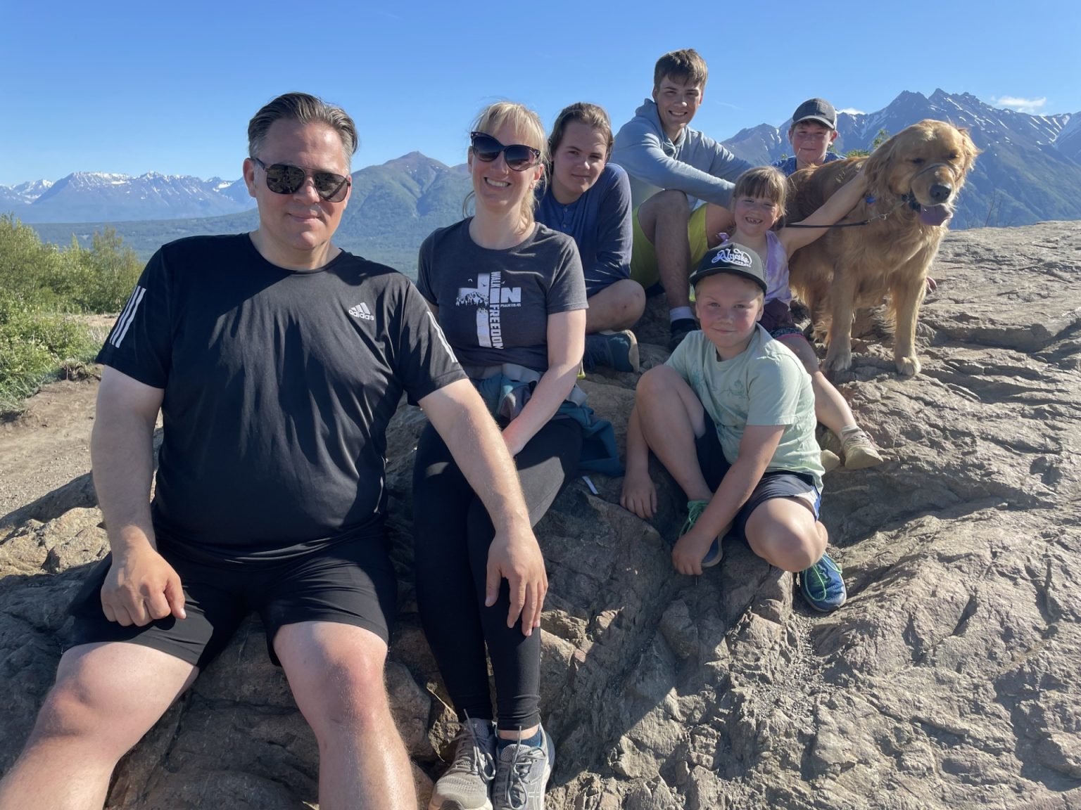 Philip Licht and his family on a mountain summit above the Matanuska Valley